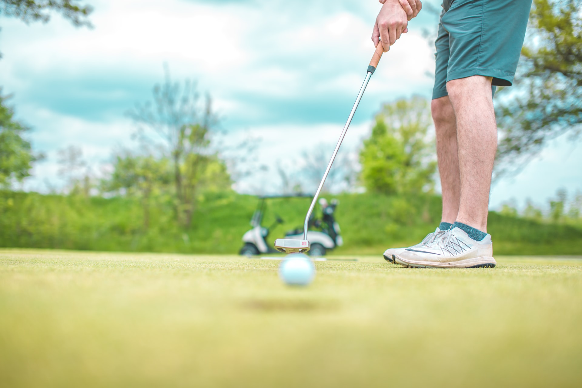A golf green in the mountains on a clear summer morning