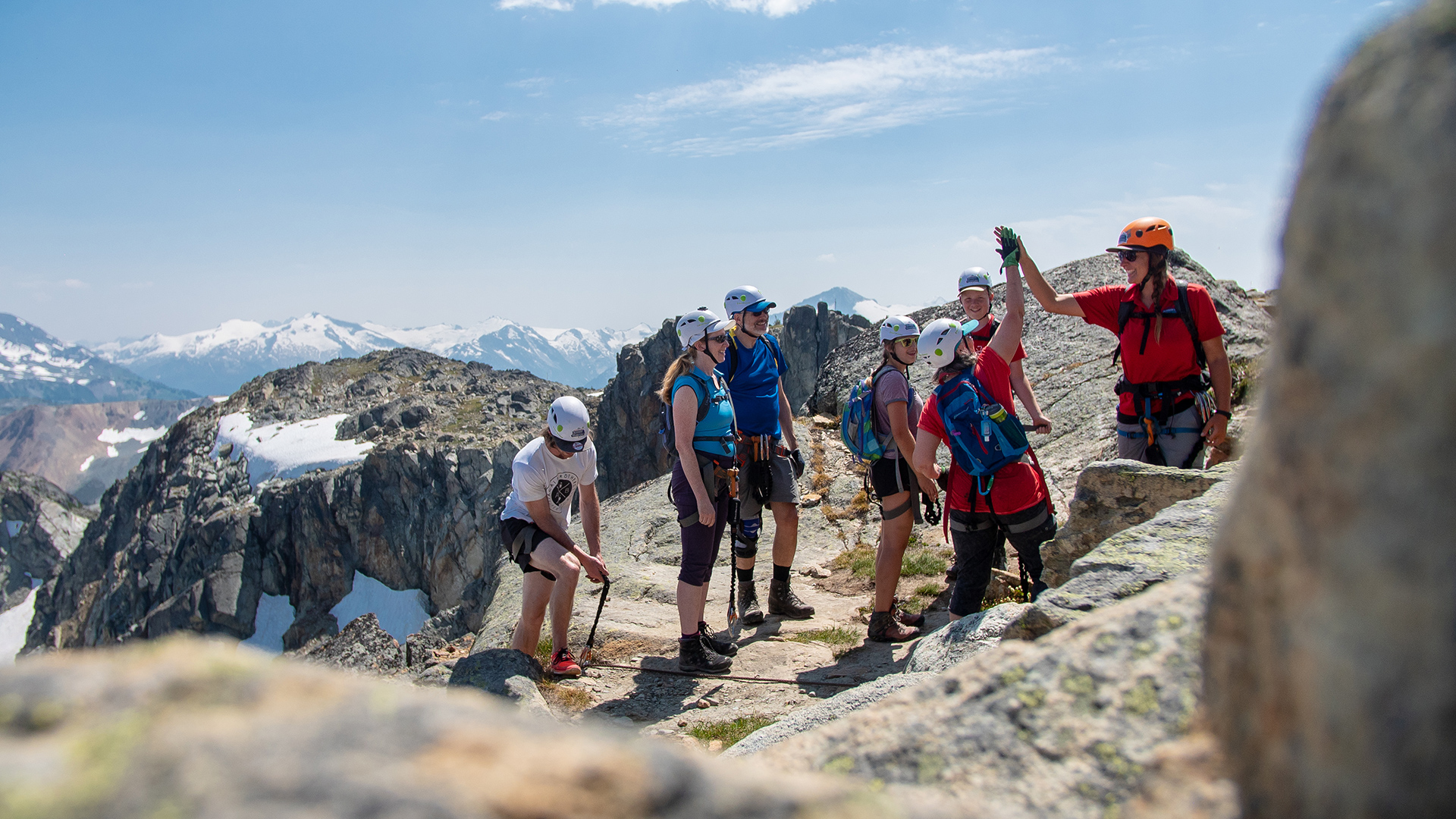 Climbers on the Whistler Mountain via ferrata with the alpine and glaciers behind