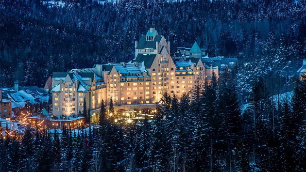 Fairmont Chateau Whistler entrance on a snowy winter evening at the base of Blackcomb Mountain