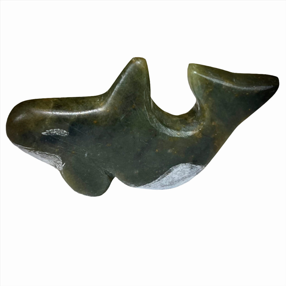 A small dark green soapstone orca carved in a Fathom Stone Art class