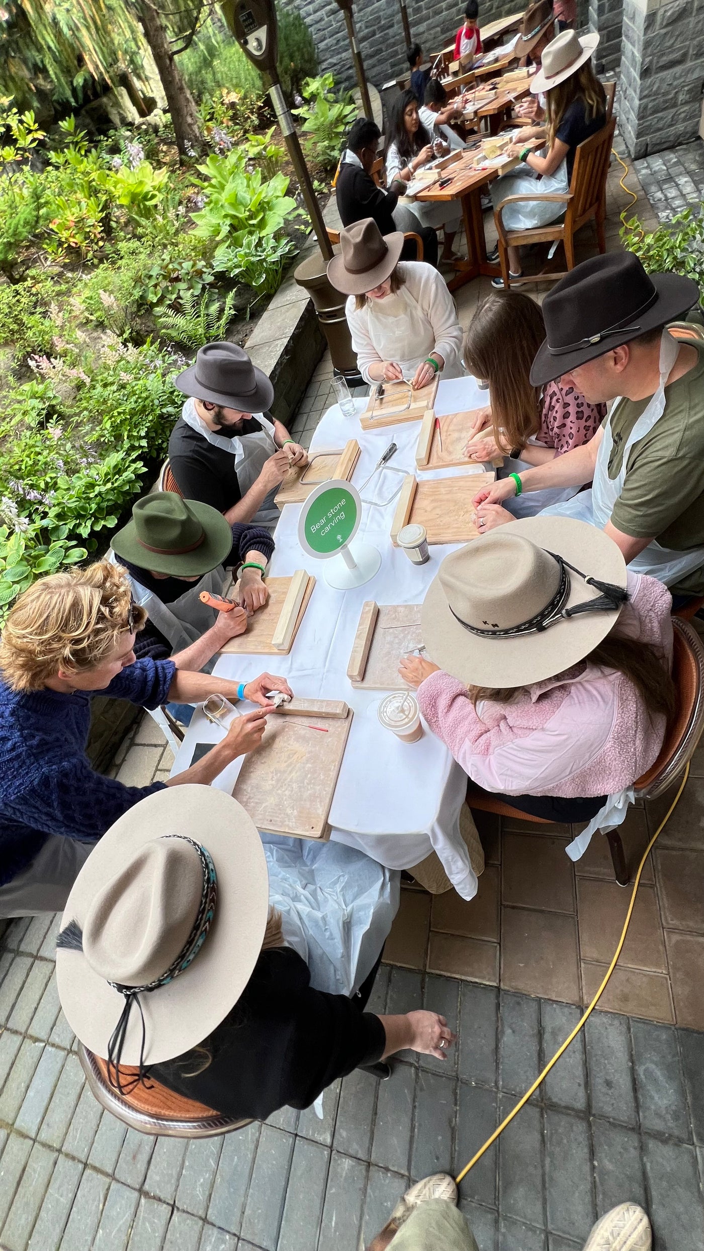 A group carving soapstone around long tables at a mobile Fathom Stone Art workshop