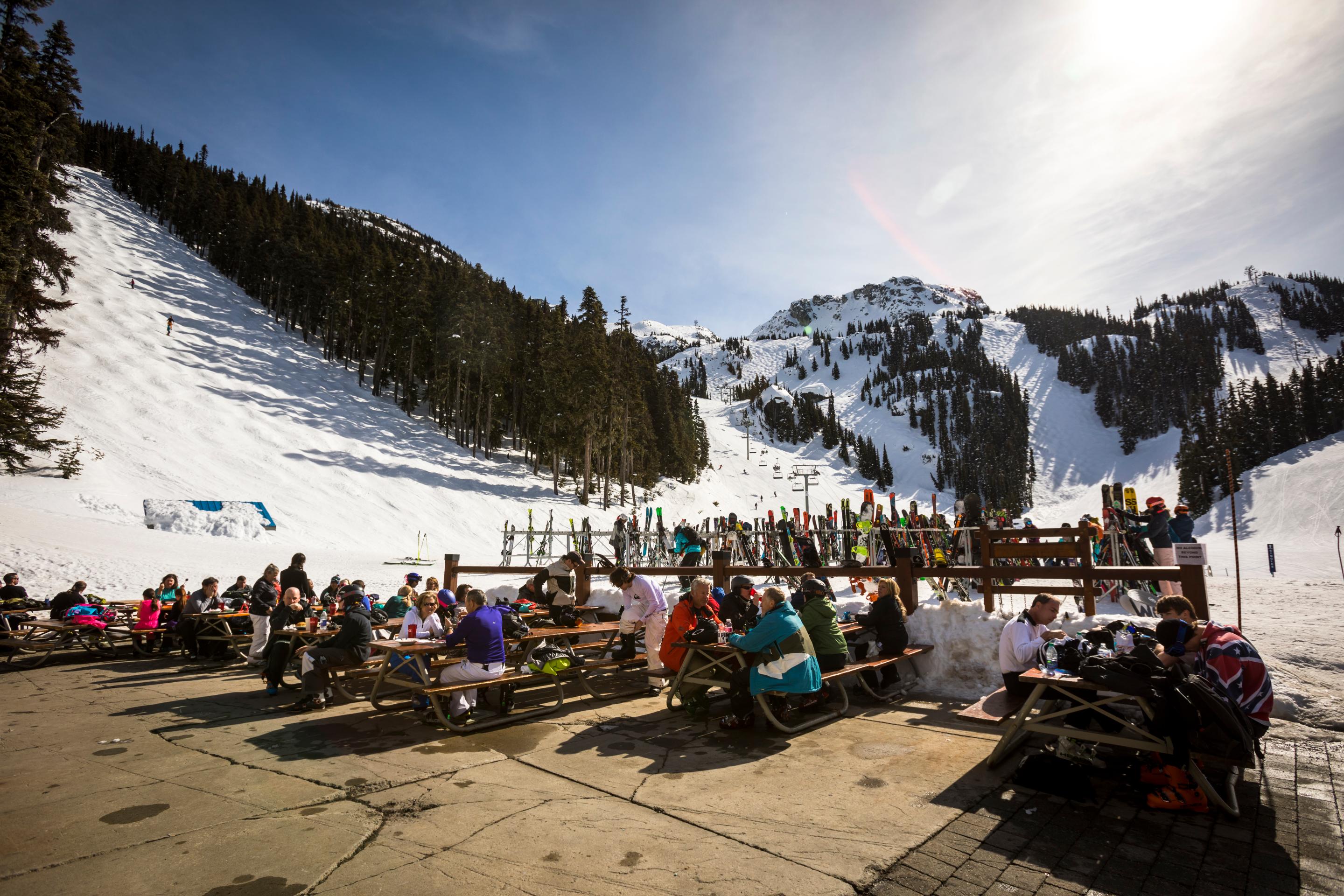 A busy sunny patio at Glacier Creek Lodge below the Blackcomb alpine