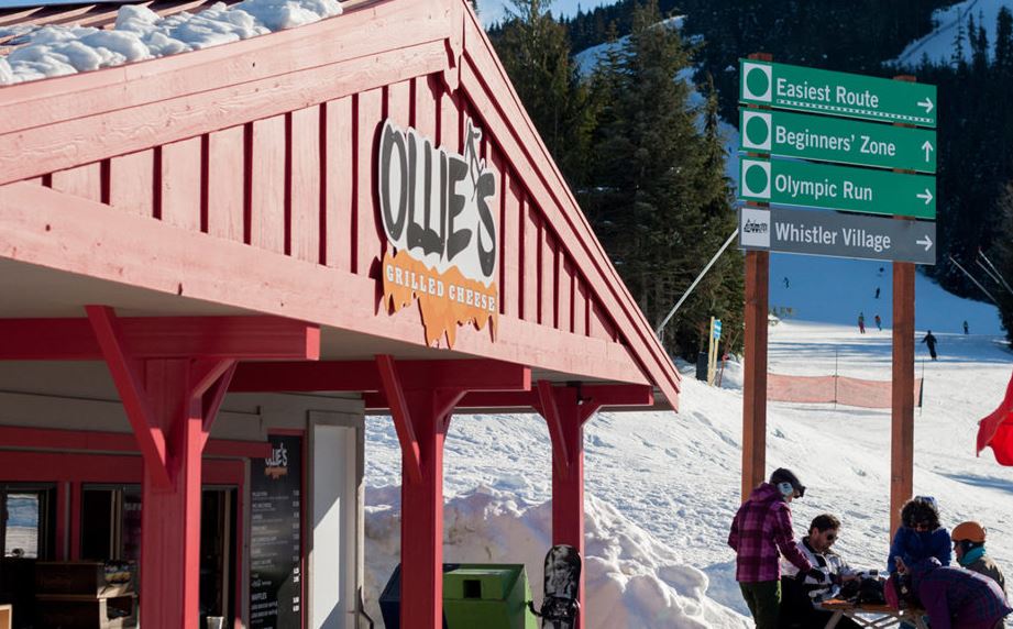 Skiers outside the red grilled cheese hut at Ollie's on Whistler Mountain
