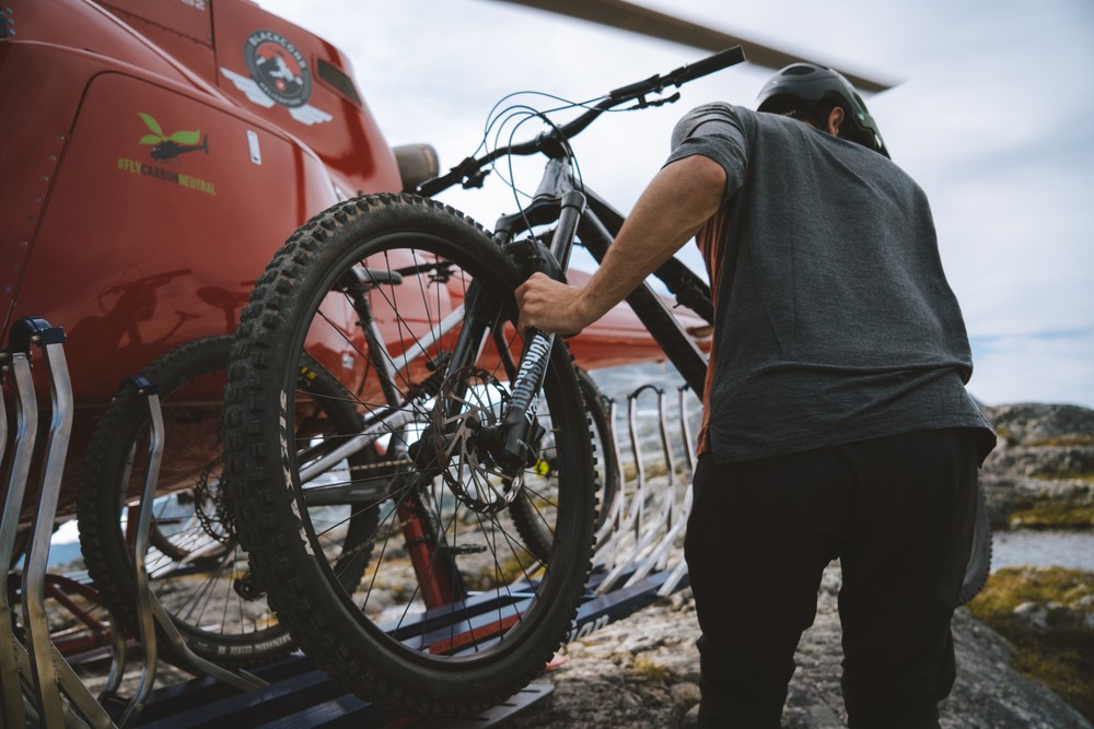 Mountain biker descending from the alpine after a helicopter drop