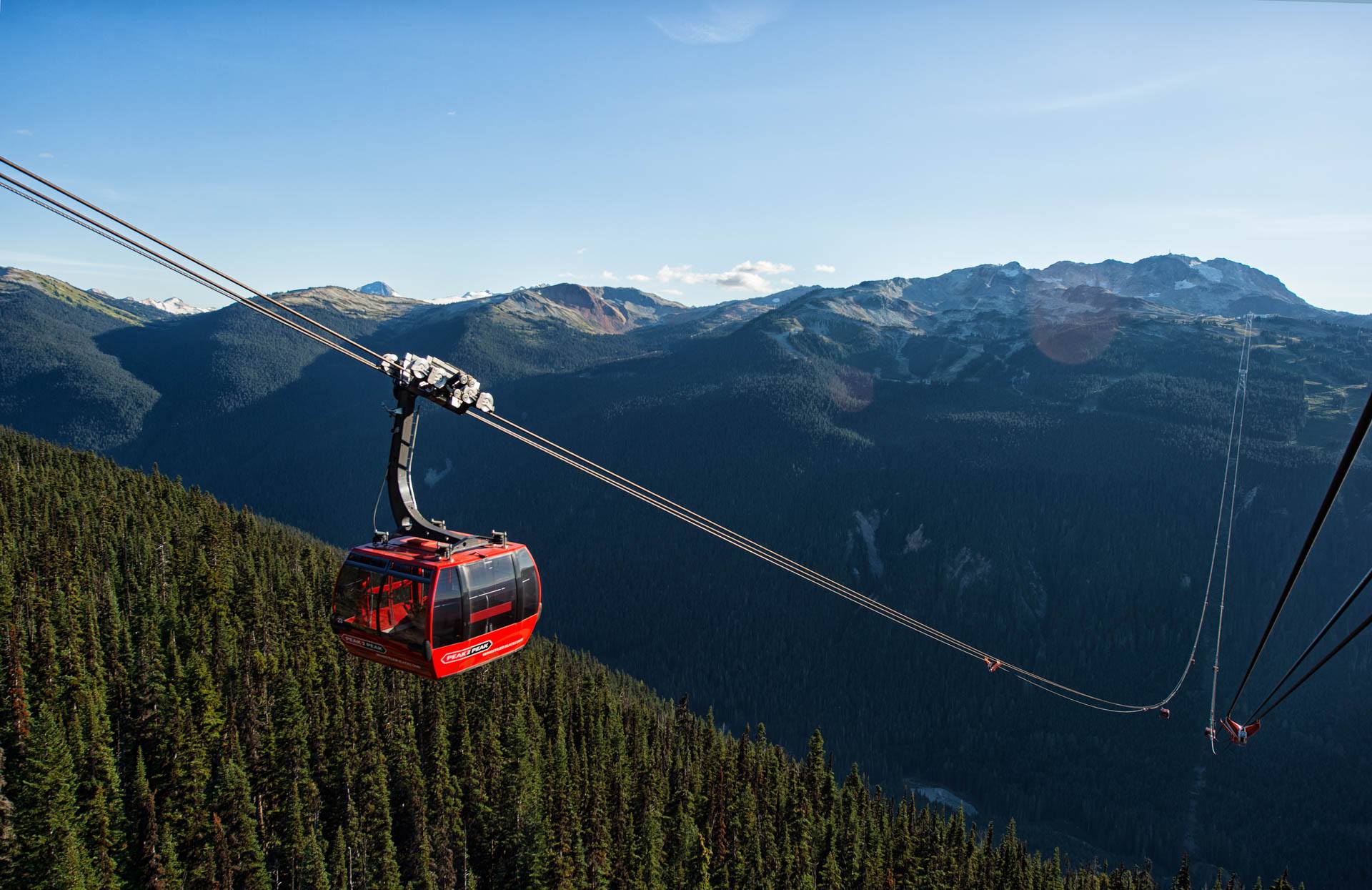 The PEAK 2 PEAK Gondola above summer forest on the way to lunch at the Roundhouse