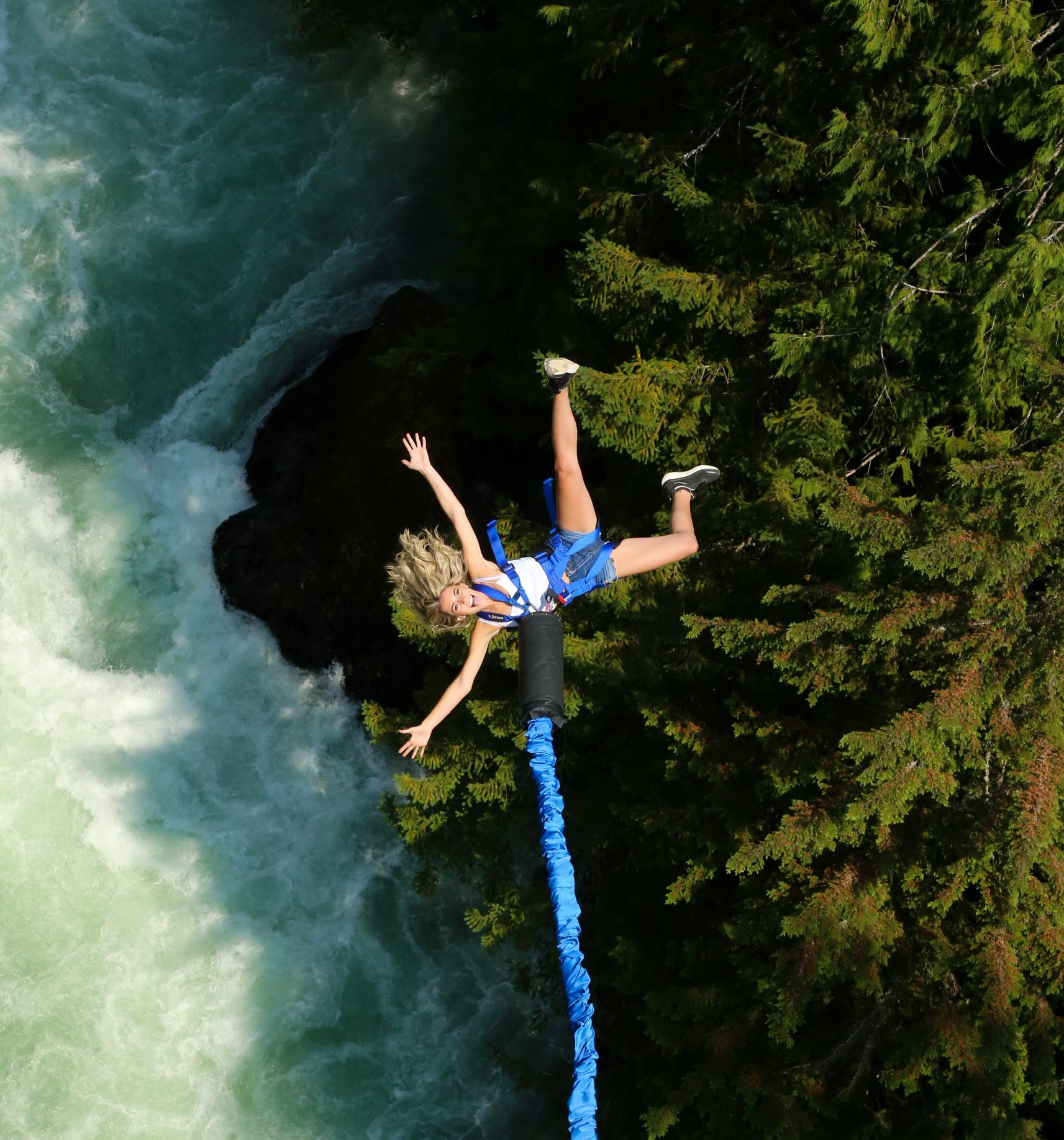 A jumper mid-leap from the Whistler Bungee bridge above the Cheakamus River canyon