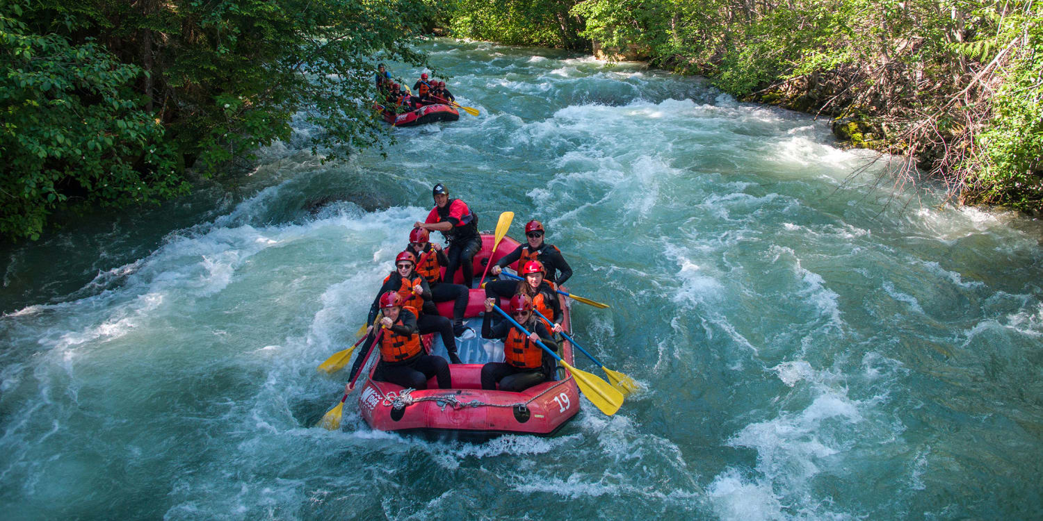 A raft full of paddlers hitting a wave on the Green River near Whistler